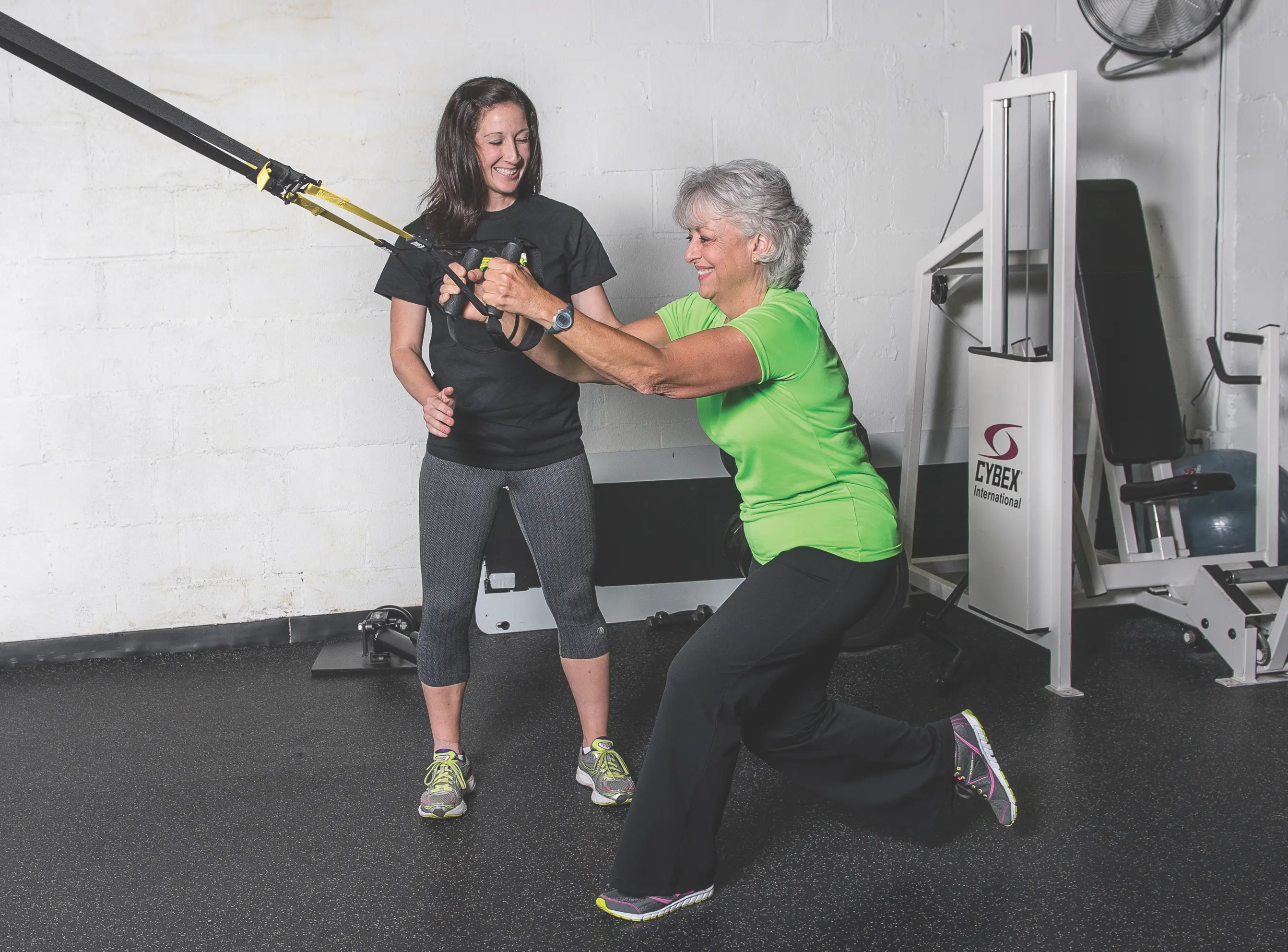 A female trainer in Lexington, KY helps with a Strong Over 50 client