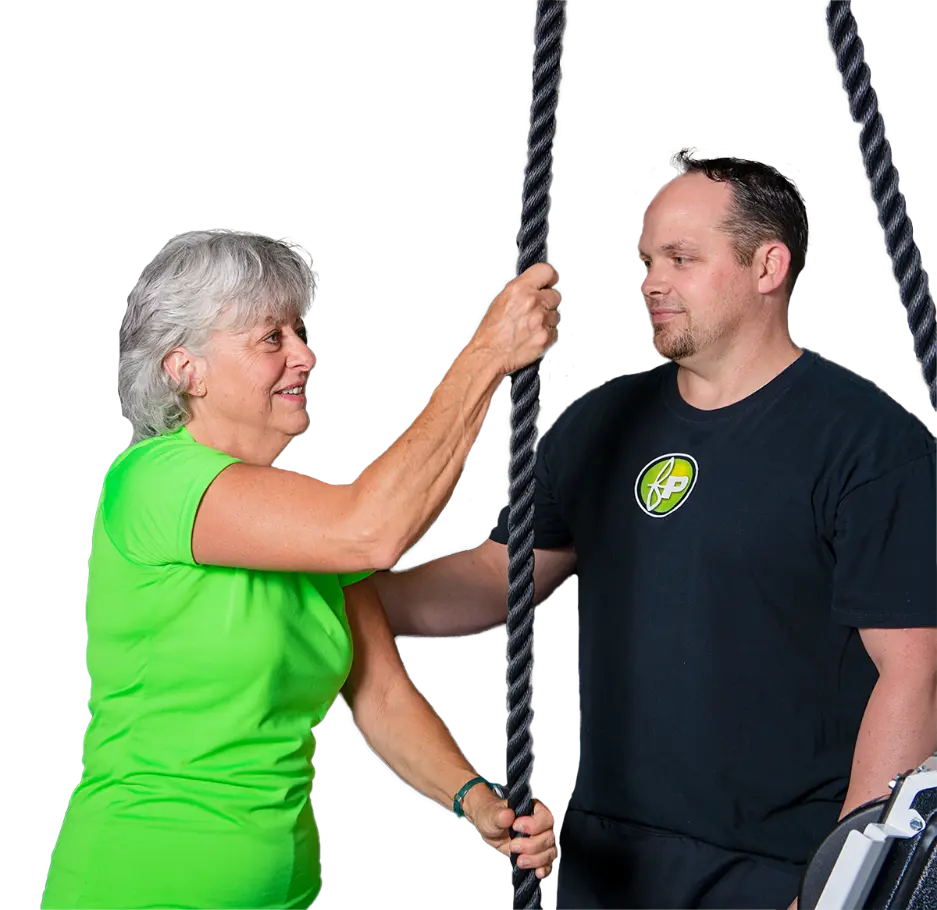 Fitness Plus personal trainer helps an over 50 year old female client
